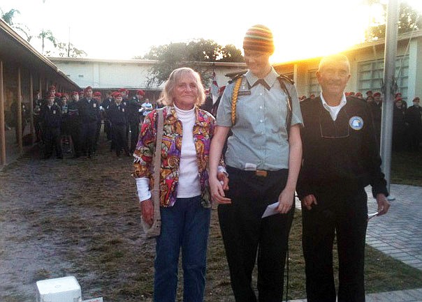 Luella Crofut presented Ashley Kruger, middle, with a check of the garage-sale proceeds she raised in KrugerÃ¢â‚¬â„¢s honor. At right is Sarasota Military Academy Headmaster Daniel Kennedy.
