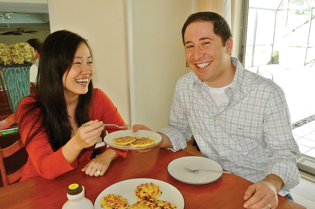 Chung-Yon Hong and Daniel Jordan share a plate of cottage cheese pancakes. Photo by Loren Mayo.