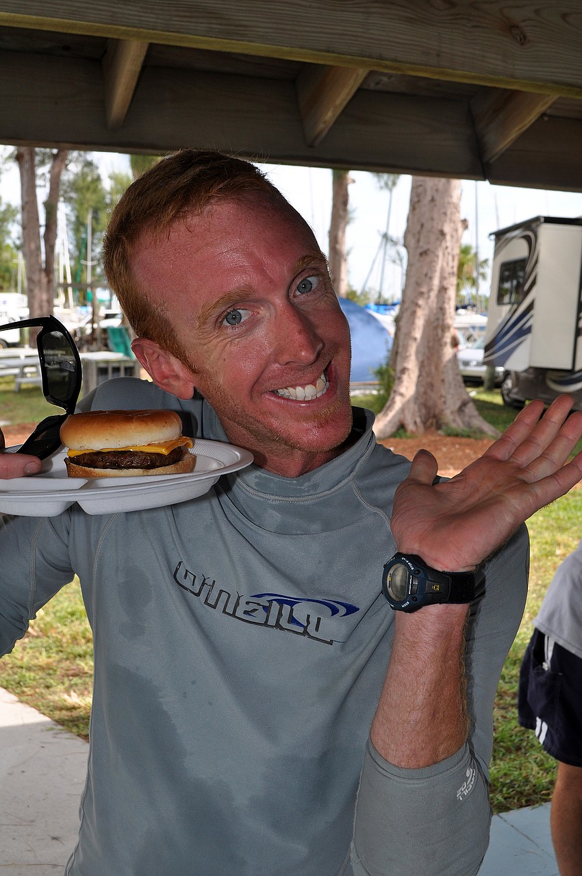 Erik Miller shows off his cheeseburger Saturday, Sept. 3 during the 65th Labor Day Regatta at the Sarasota Sailing Squadron.