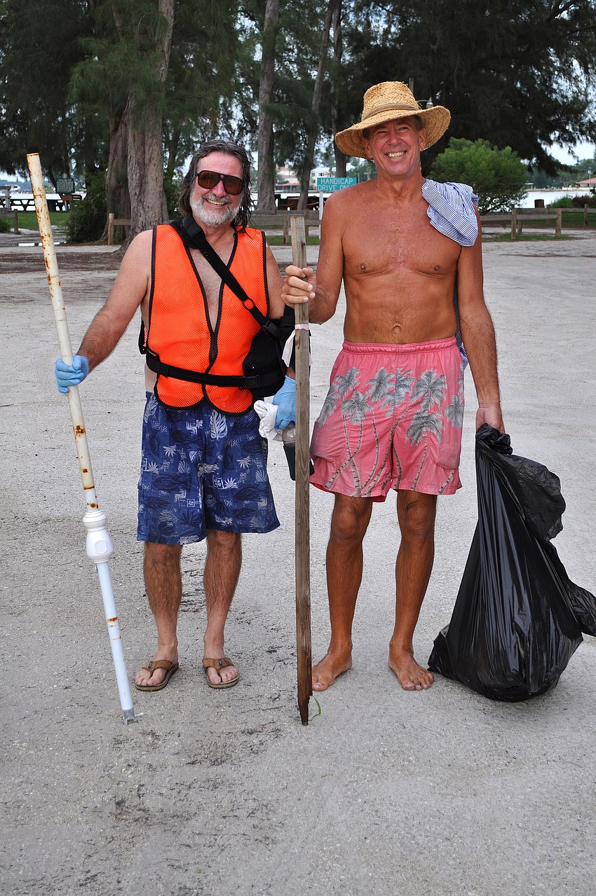 Mitch Malone and Gary Sibole filled two garbage bags during the Barefoot Wine Beach Cleanup Thursday, Sept. 8, at Ted Sperling Park.