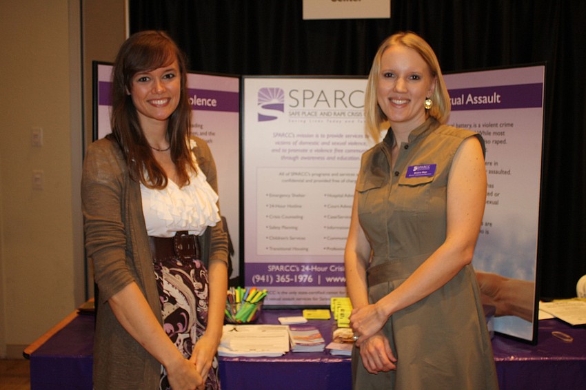 Educator Theresa Lochhaas poses with Director of Community Awareness Jessica Hays in front of their Safe Place and Rape Crisis Center booth.