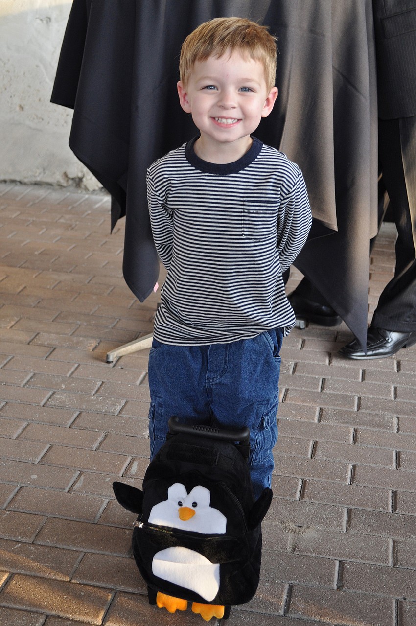 Cooper Nickelson flaunts his penguin rolling back-pack that he got earlier in the day