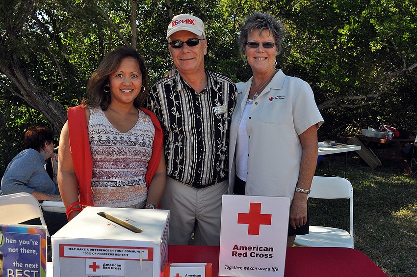 Beverly Arias, Benny Kimsey and Kimberley Reibel pose together by the Red Cross table.