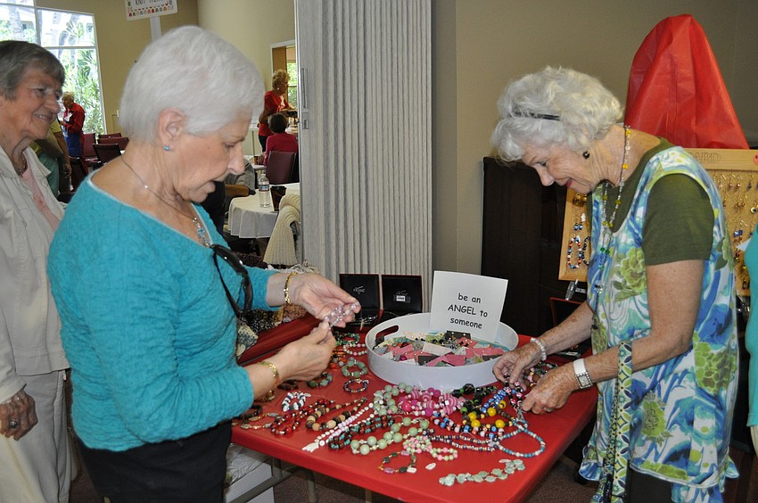 Clara Wingart and Libby Biedermann admire the hand-made jewelry
