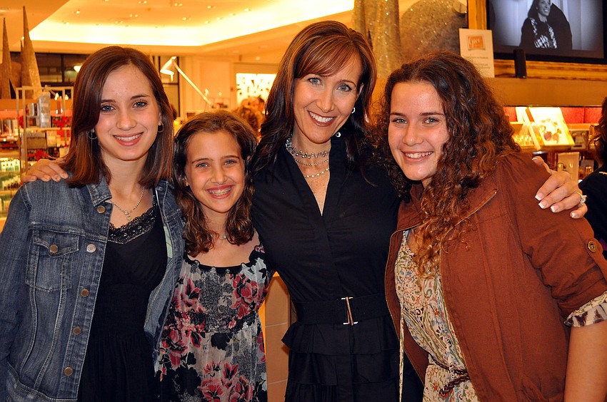 Sydney, 14, Alex, 11, Stacy and Samantha, 14, Hanan pose together, Wednesday, Nov. 30, inside Saks Fifth Avenue at Westfield Southgate.