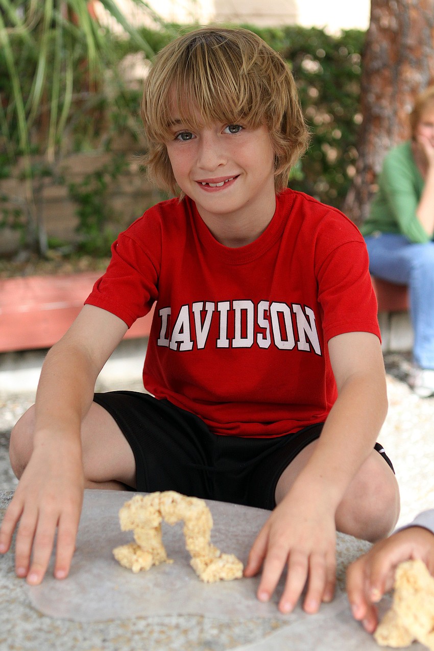 Sawyer Dunn-Matrullo, 8, makes a tabby archway out of rice krispie treats.