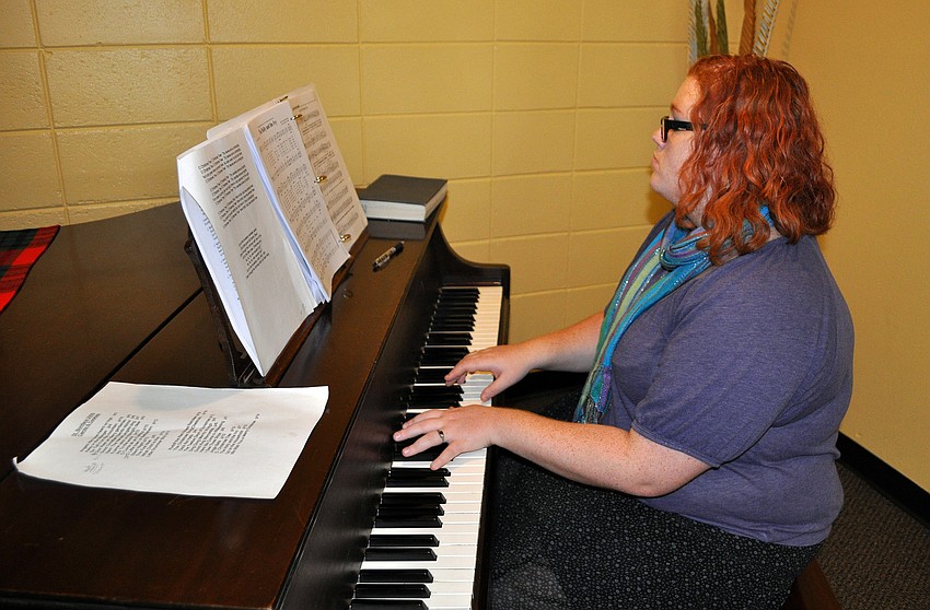 Lily Wohl played Christmas carols on the piano inside the Parish Hall.