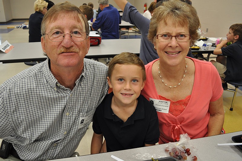 Glenn and Deborah Greenwood with their grandson, Judson Hildreth, center.