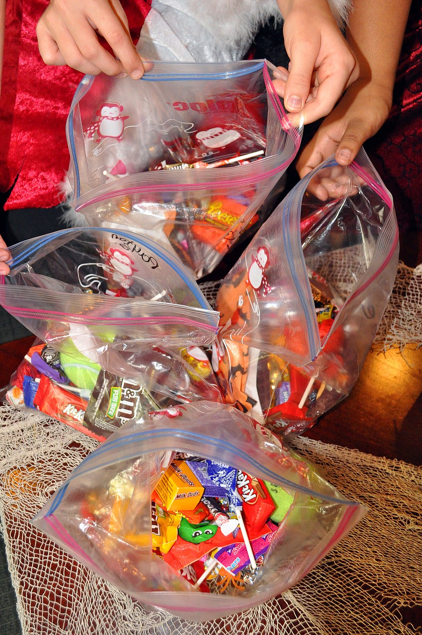 The girls show off the candy they collected from Merrill Lynch, UBS, and Boarâ€™s Head, Friday, Oct. 28, during their trick-or-treating event at the Sarasota City Center Office Building.