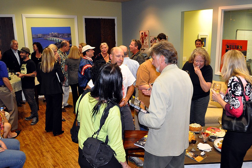 Dozens of people came out to meet and talk with artist and author, Kurt Wenner, Wednesday, Nov. 2, at J Wood Realty.