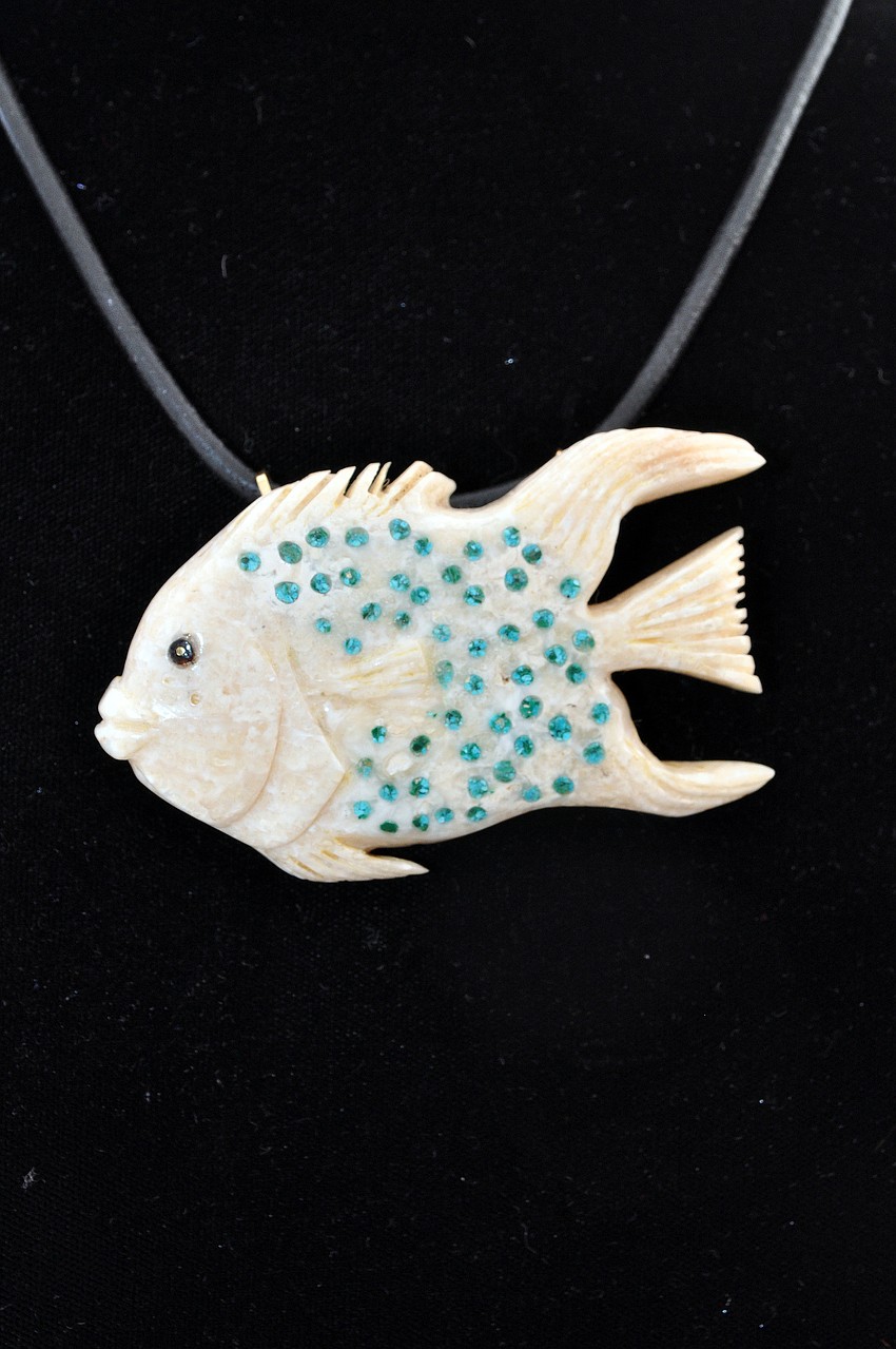 A French Angel necklace made of turquoise, fossil, coral and 14 karat gold was created by Ms. Michael Rubin Stewart of Black Coral.