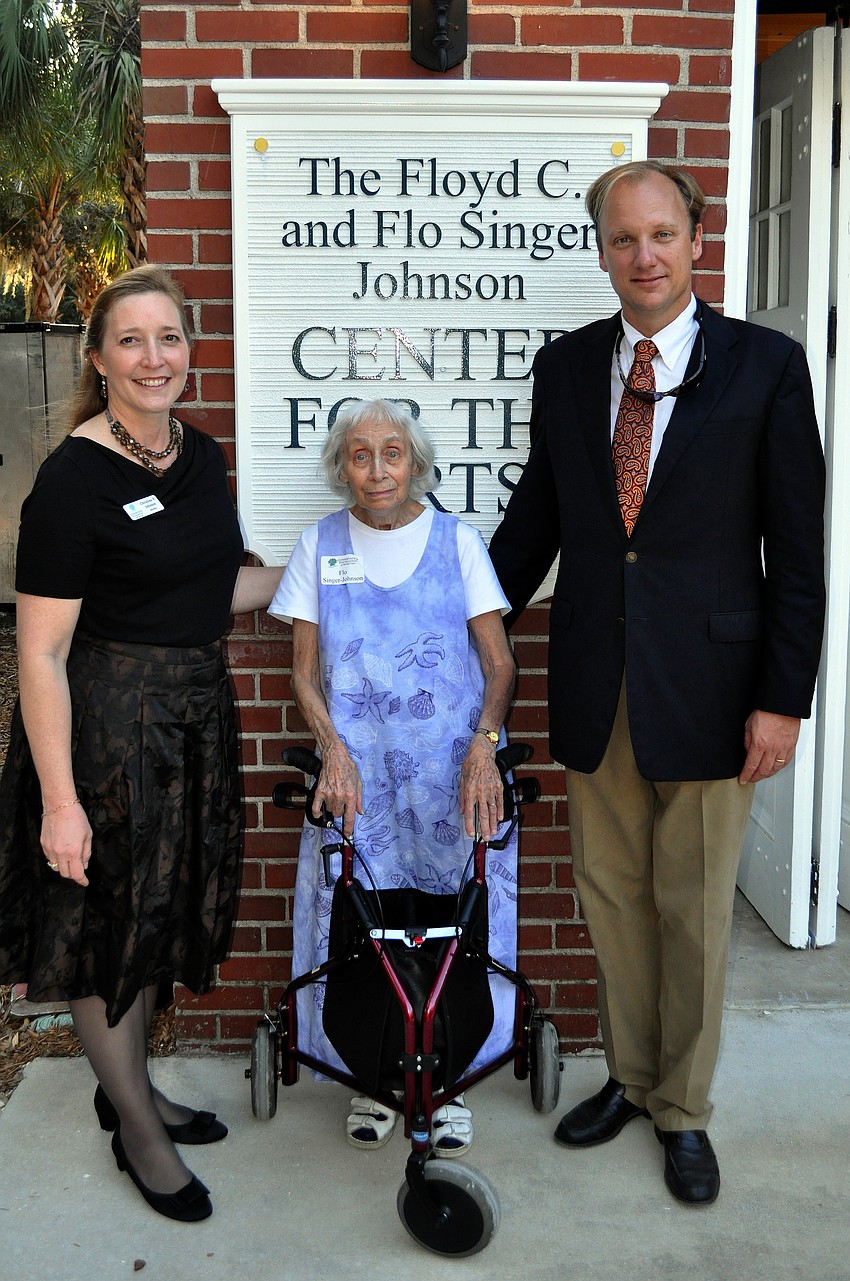 President Christine P. Johnson, Flo Singer Johnson and Founder and Chairman Albert Joerger pose together in front of one of the signs for the new Center for the Arts, Sunday, Nov. 20, out at Bay Preserve.