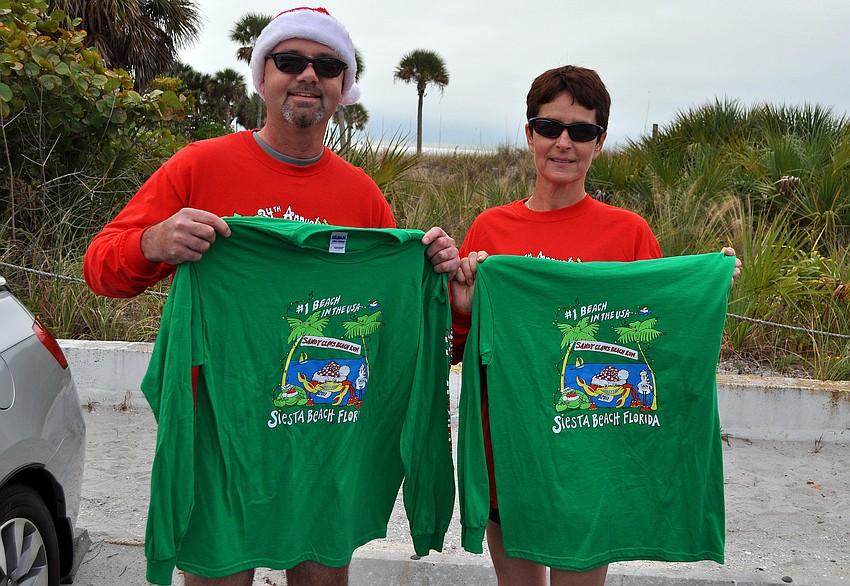 Bill Rolette and Halyna Petrova show off their new Sandy Claws shirts.