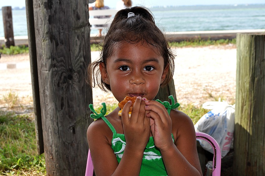 Ahnya Myers, 3 Â½, enjoys her hamburger Saturday, Sept. 3 at the 65th Labor Day Regatta at the Sarasota Sailing Squadron.