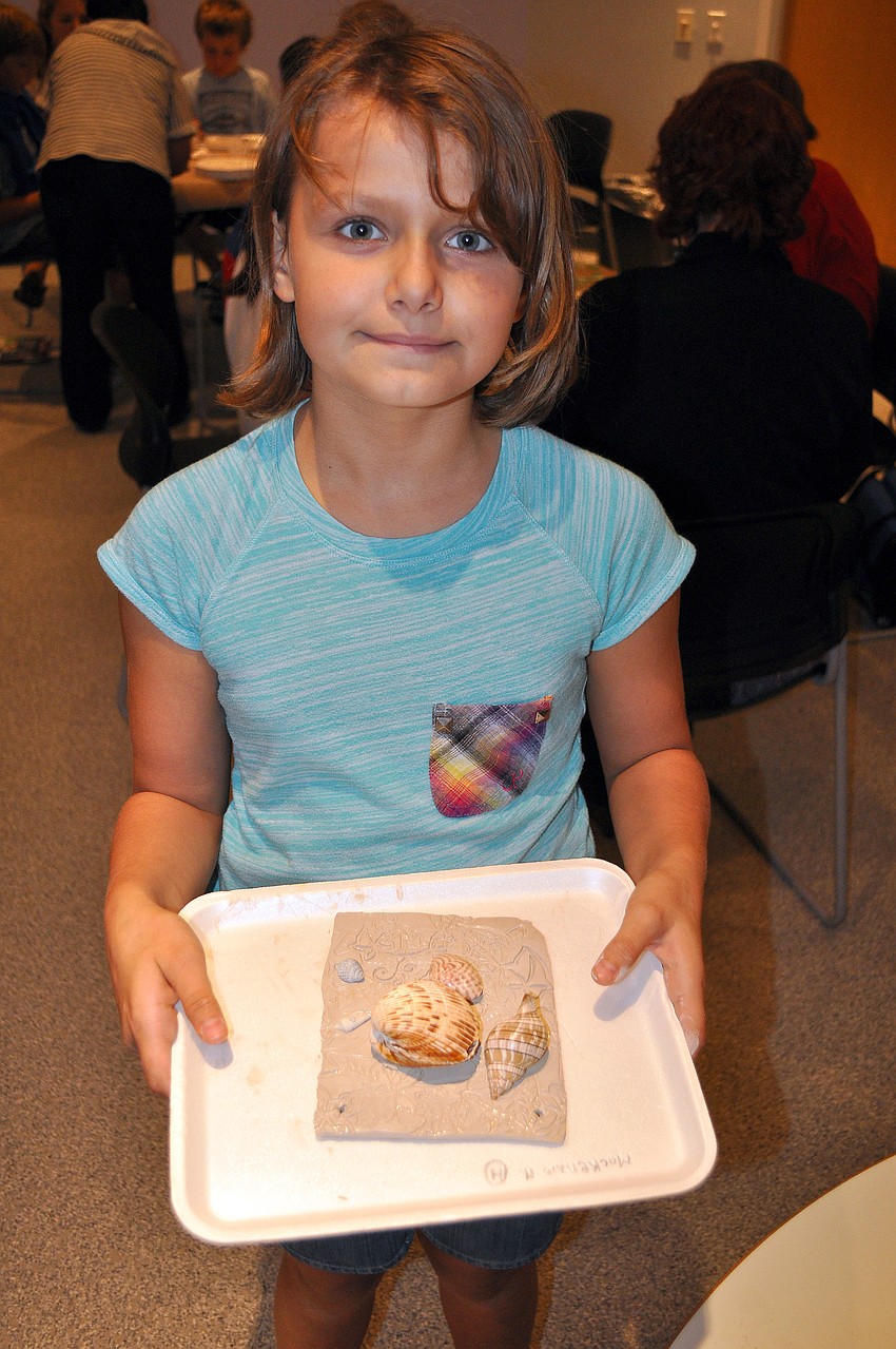 Diana Nedorezova shows off her Florida fossil plaque.