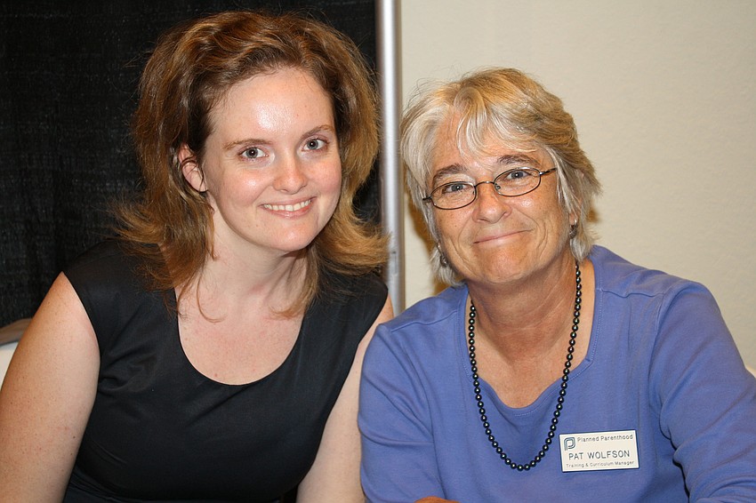 Kaitlyn Miller and Pat Wolfson in front of their Planned Parenthood booth.
