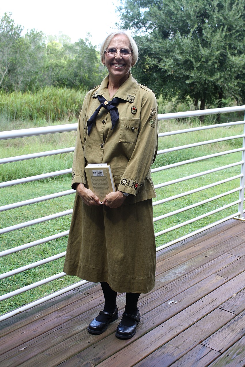 Chairman of Archive section of History and Archives Marti Schuster wears a Girl Scout uniform from the 1920s.