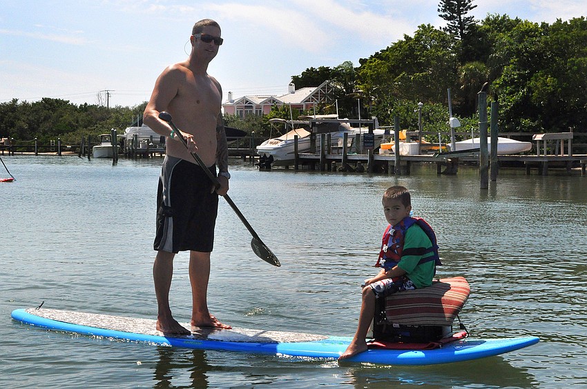 Mike Smith paddling with his son, Cash, 5, during the poker run.
