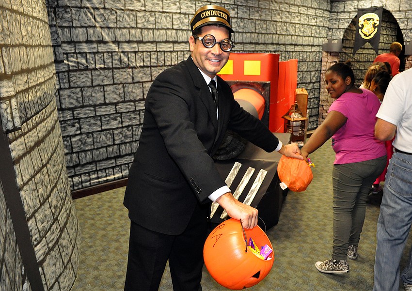 Joe Malave was dressed as the train conductor from Harry Potter as part of UBSâ€™ Halloween theme, Friday, Oct. 28, inside the Sarasota City Center Office Building.