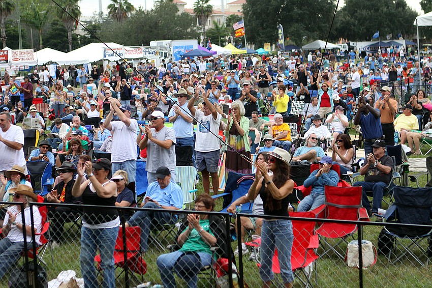The crowd cheers and claps for Lightin' Malcolm.