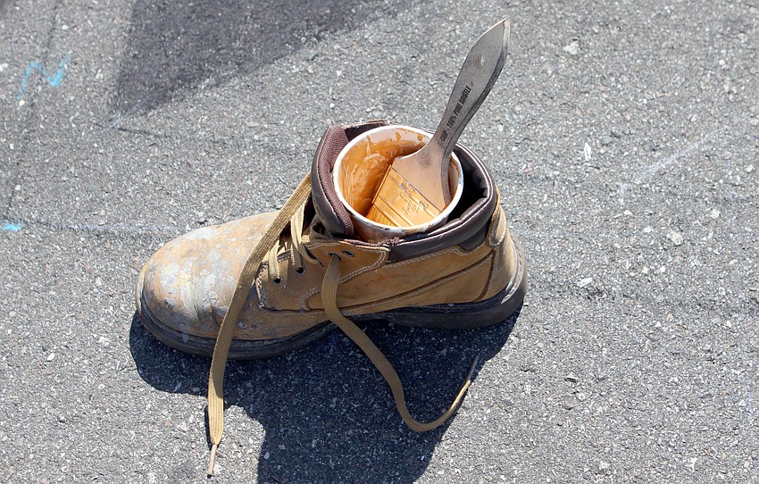 One artist kept their chalk paint cup in a shoe so that the wind would not knock it over.