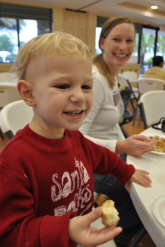 Ben Rizzo happily feasted on pancakes. His mother, Bree, watched in amusement.