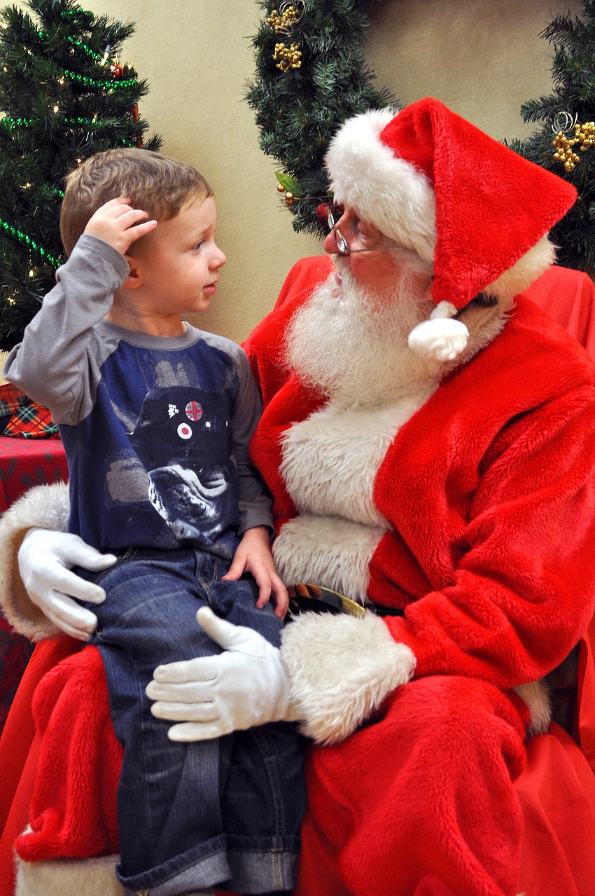 Dalton Anderson, 3, tries to figure out just what he wants to tell Santa that he would like for Christmas, Friday, November 9, during Southside Stroll.