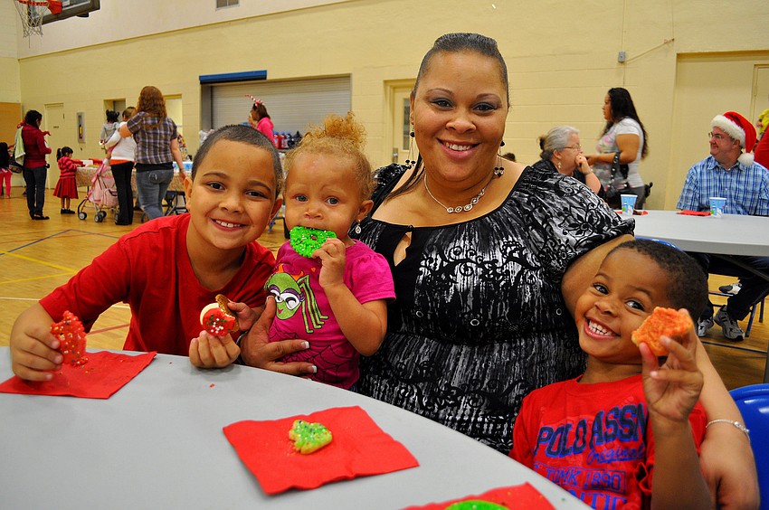 Joshua Stott, 8, Jalea Hargrove, 1, Ayesha Muhammad and Jaycen Muhammad, 4, enjoy some holiday cookies together.