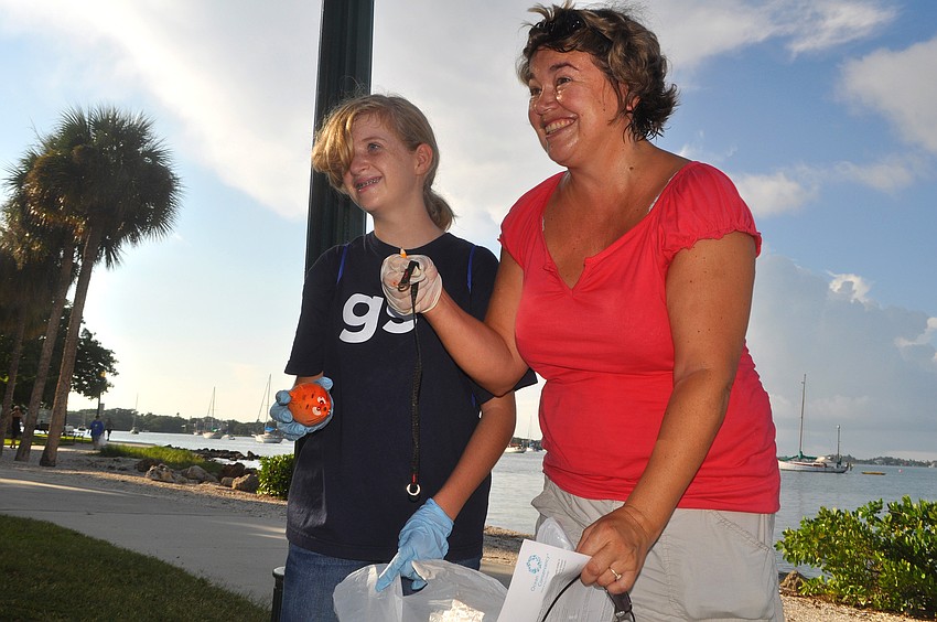 Hannah Fonte and Christine Green show off the odd things they found at Bayfront Park Saturday, Sept. 24, during the International Coastal Cleanup.