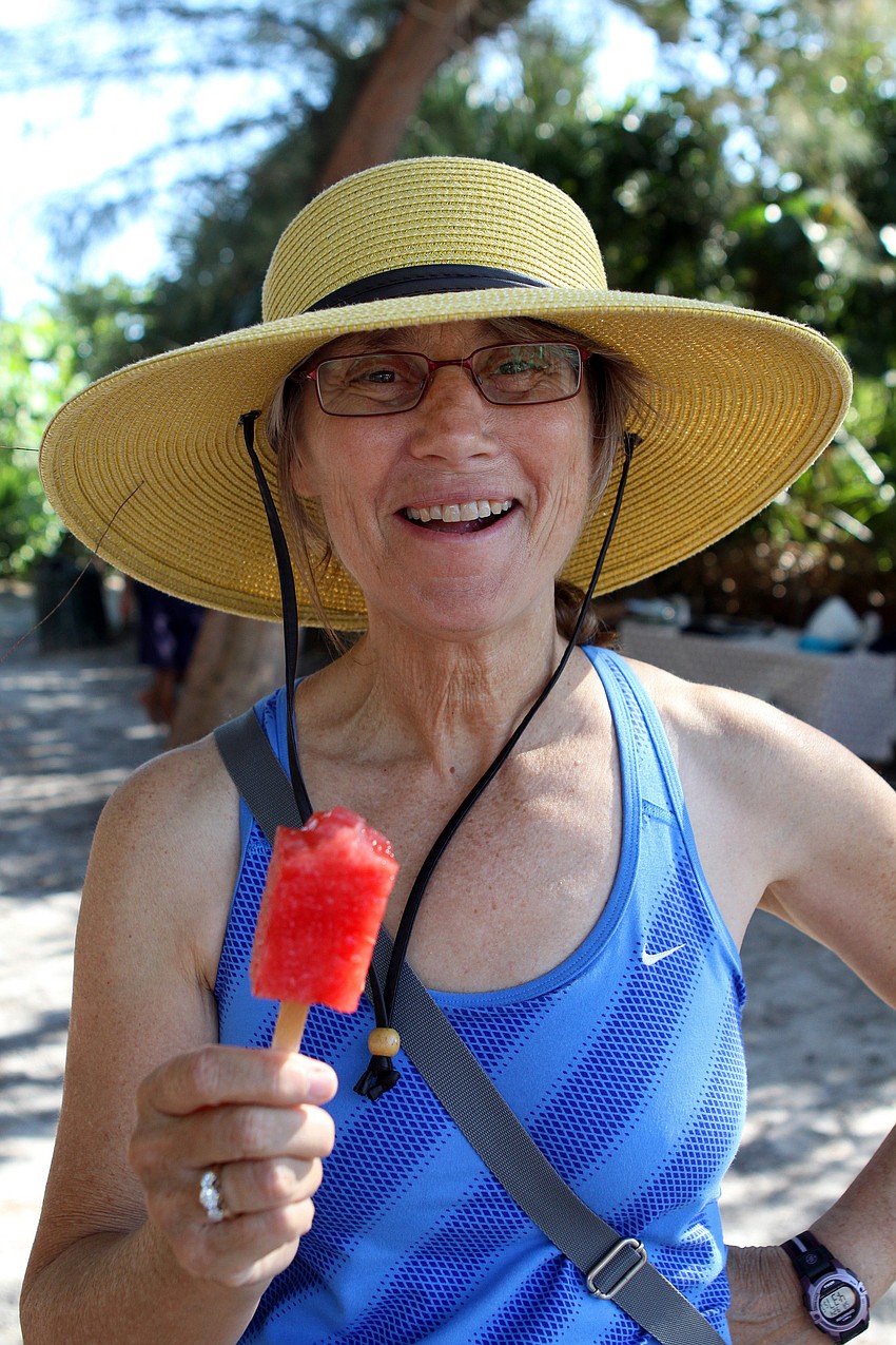 Julie Morris enjoys one of the watermelon pops Saturday, Sept. 24 at Siesta Key Public Beach.