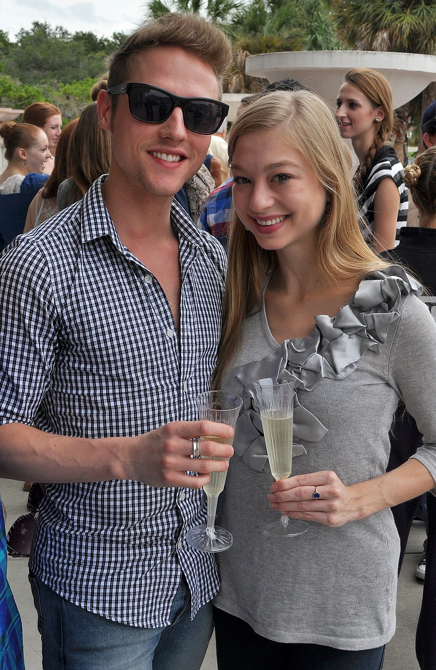 Simon Mumme and Anais Blake, both dancers who went to Washington, D.C., pose together with their glasses of champagne.