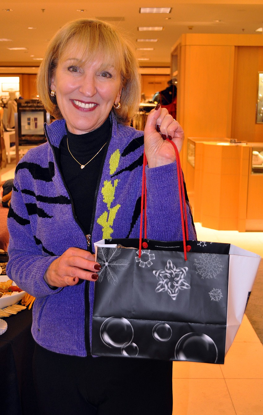Judy Cahn shows off her shopping bag filled with goodies.
