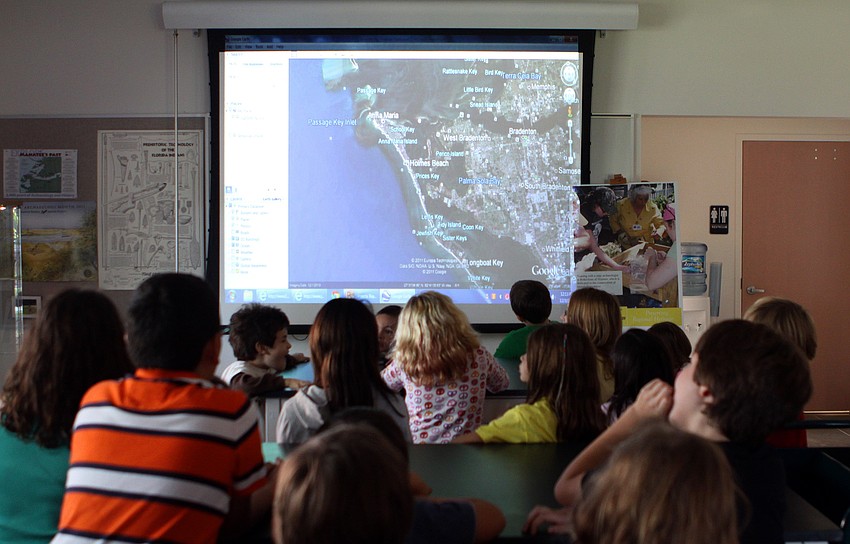 Fruitville Elementary students listen to a presentation about the geography of Florida and Florida's waterways, Saturday, Dec. 3, during Fruitville Elementary's junior archaeology day at New College's Public Archaeology Lab.