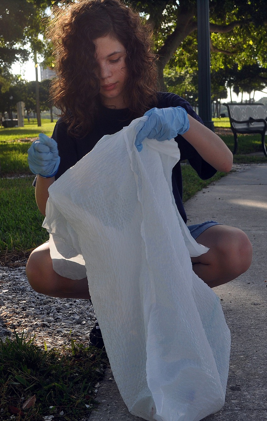 Savannah Franz, 12, picks up cigarette butts at Bayfront Park.