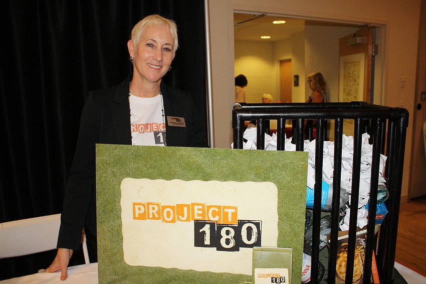 Executive Director of Project 180 Barbara Richards poses in front of her booth.