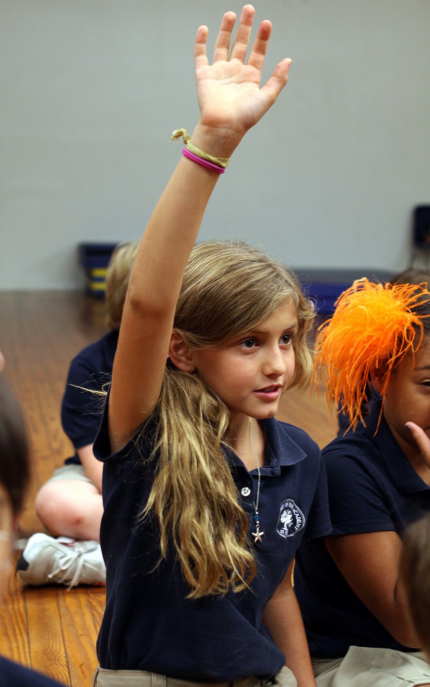 Elle LeClair, 9, raises her hand to answer a question asked by artist Jack Dowd Thursday, Oct. 13 at ODA.