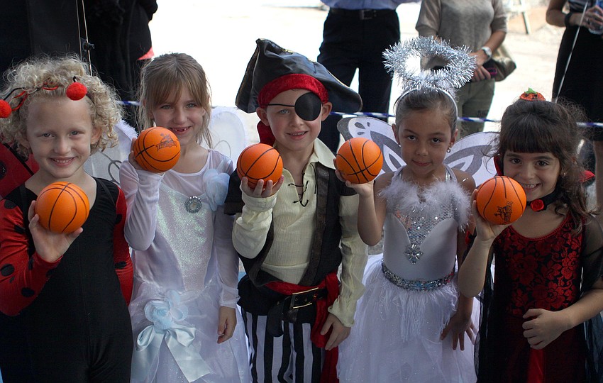 Claire Giraud, Eden Harris, Zachary Szabo, Lauren Toro and Tara Torahan, 5, show off their mini basketballs, Monday, Oct. 31, as part of the opening of the Lower School Athletic Pavilion donated by the Dart Family at Out-of-Door Academy.