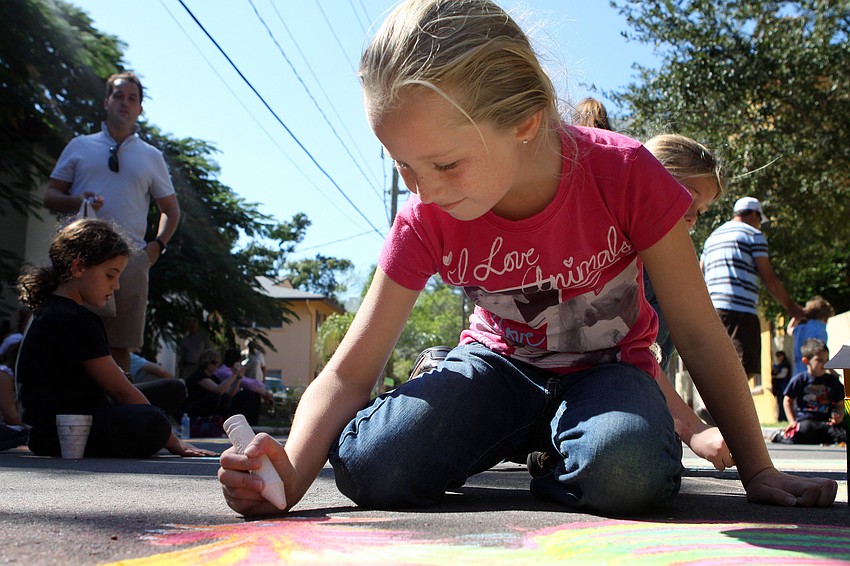 Brianna Ream, 7, made a rooster in the kids area, Saturday, Nov. 5 in Burns Court.