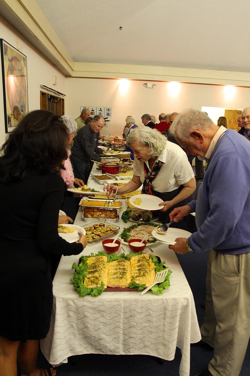 People made their way through two lines to get dinner and dessert during Longboat Key Garden Clubâ€™s Candy Cane Lane holiday party.