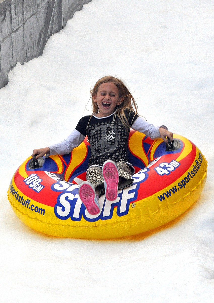 Blythe Snyder, 7, has fun going down the Snow Slide, Friday, November 9, during Southside Stroll.