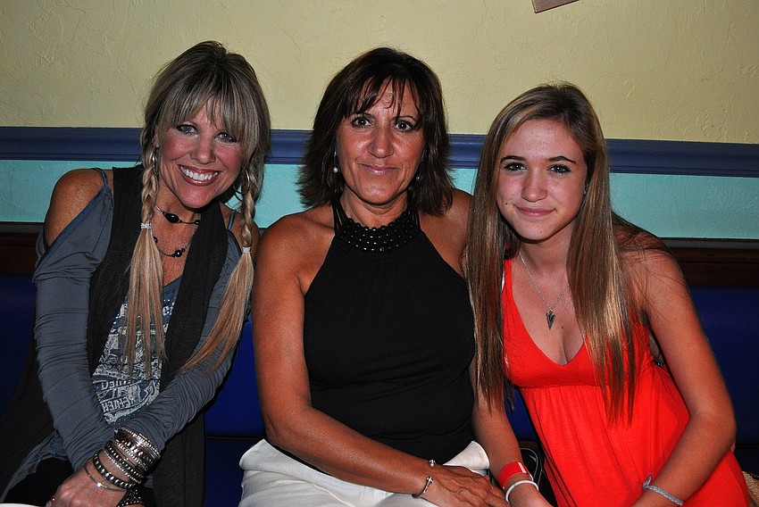 Susie Chinn sits with Carmen and Victoria Blair Thurday, Oct. 6 during the 11th annual Okto-Paw-Fest at the Daiquiri Deck on SIesta Key.