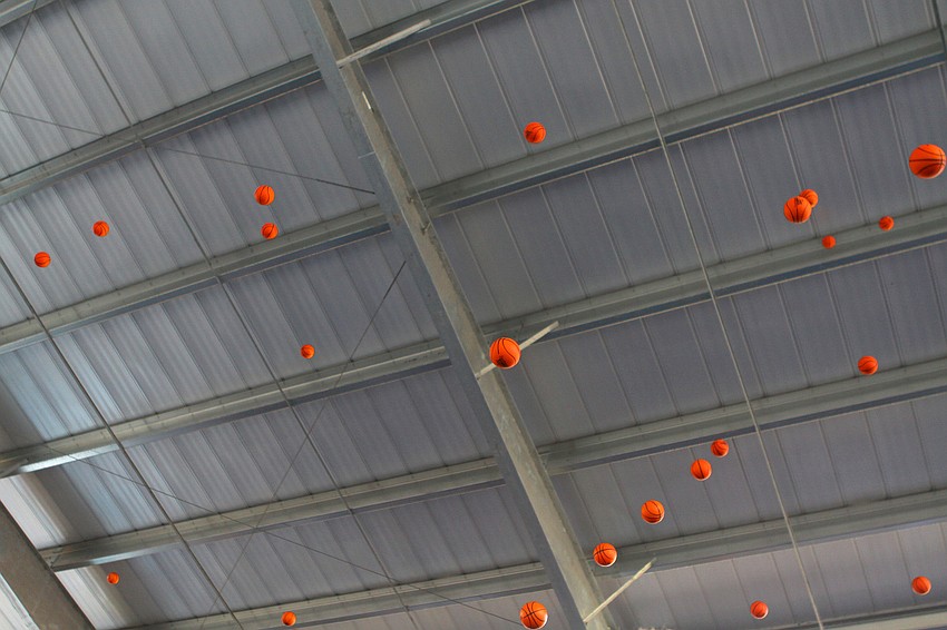 Students and faculty threw mini basketballs into the air, Monday, Oct. 31, as part of the opening of the Lower School Athletic Pavilion donated by the Dart Family at Out-of-Door Academy.