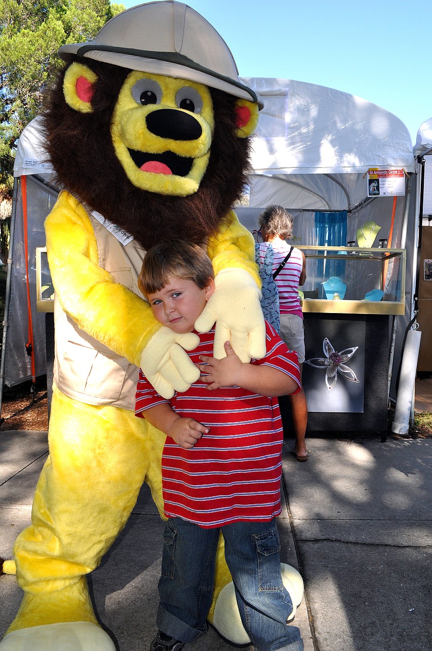 Thomas Campbell, 4, got a photo of Touch of Africa's Lenny the Lion.