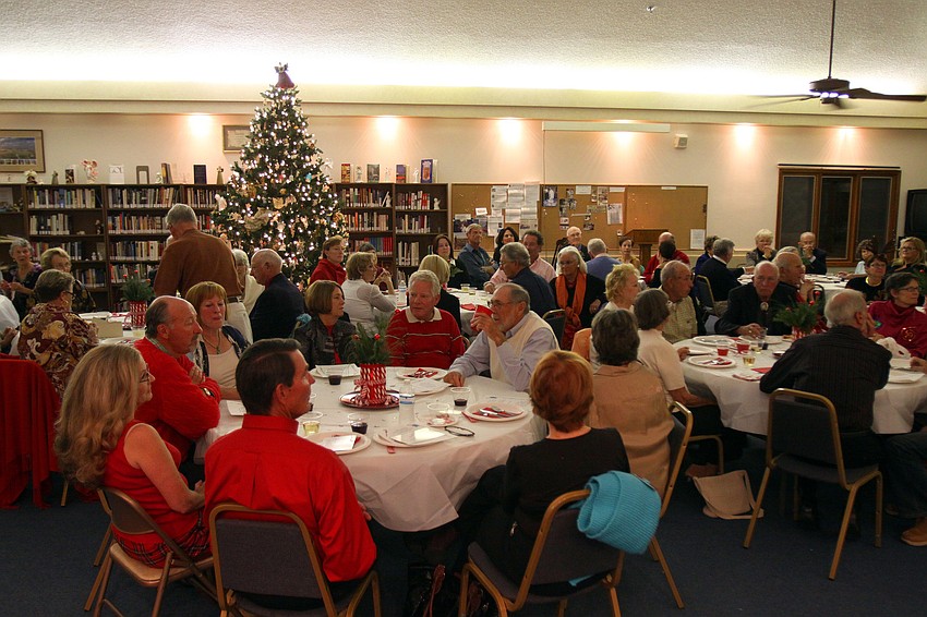 People sat around tables inside All Angels by the Sea, Thursday, Dec. 8 during Longboat Key Garden Clubâ€™s Candy Cane Lane holiday party.