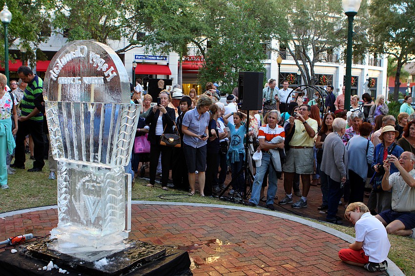 People took many photos and studied the beautiful ice menorah during A Taste of Chanukah, Tuesday, Dec. 20 at Five Points Park.