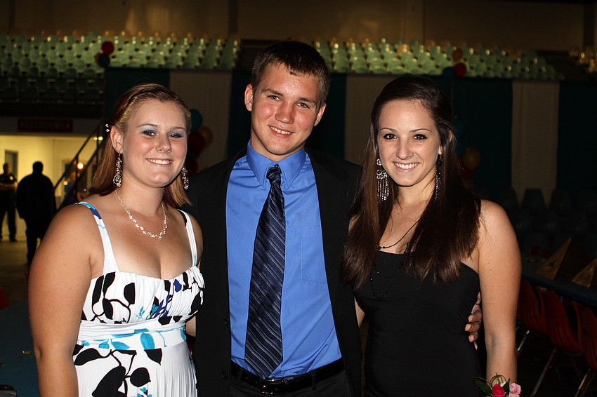Colleen Davies, Kyle Kerns and Victoria Dowsland pose together, Saturday, Oct. 15 during the Sarasota High School homecoming dance at Robarts Arena.