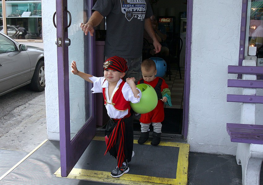 JR, 3, and Rocco, 1, Ryan leave Big Olaf after getting some treats, Monday, Oct. 31, during the Safe Kids trick-or-treating event in Siesta Key Village.