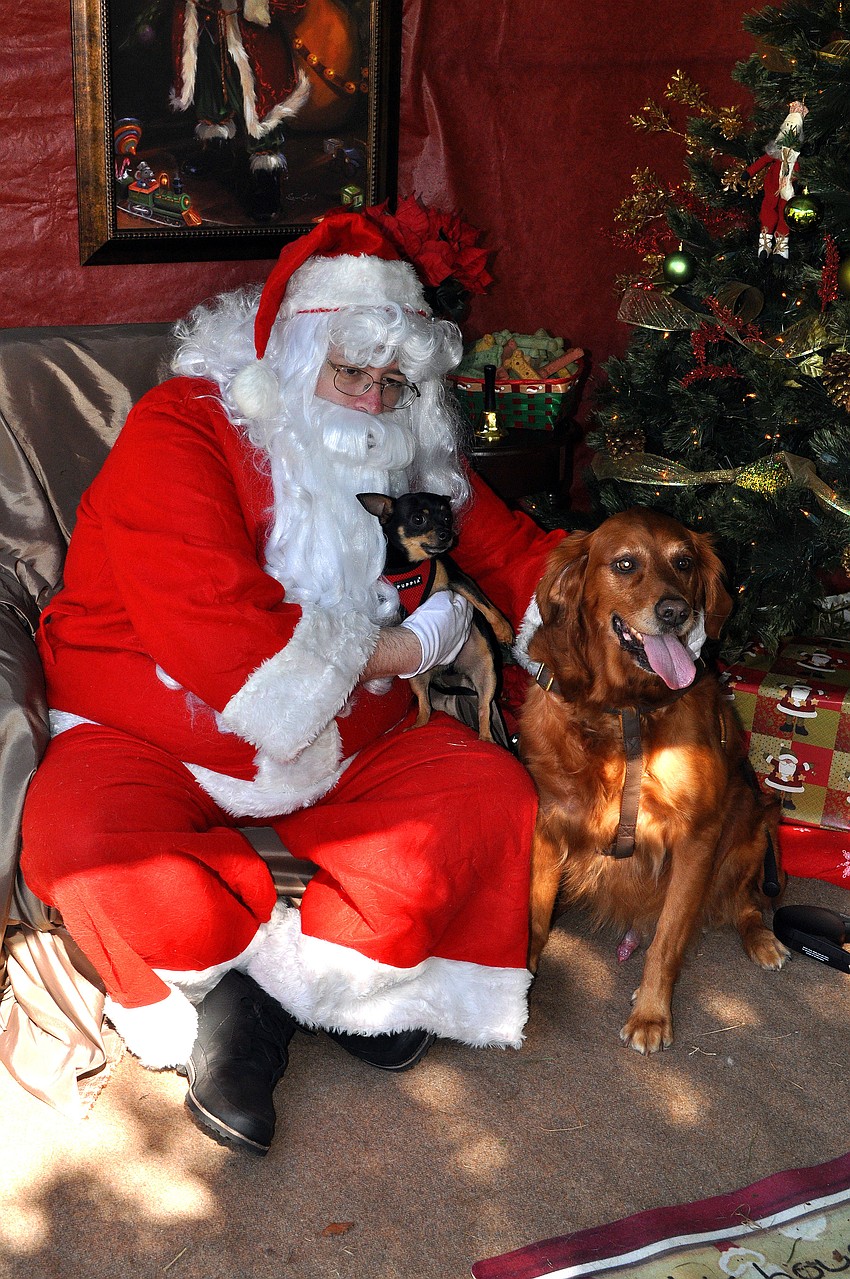 Roper, 3 1/2, and Rio, 8, get their picture taken with Santa, Saturday, Nov. 12, at Golden Fest out at Historic Spanish Point Park.