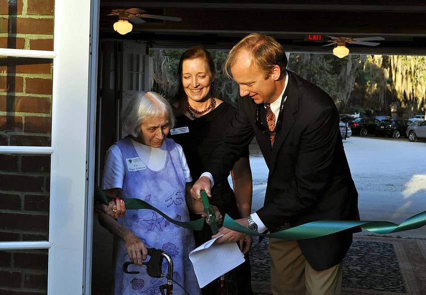 Flo Singer Johnson and Albert Joerger cut the ribbon for the grand opening of the Center for the Arts as Christine P. Johnson looks on, Sunday, Nov. 20, out at Bay Preserve.
