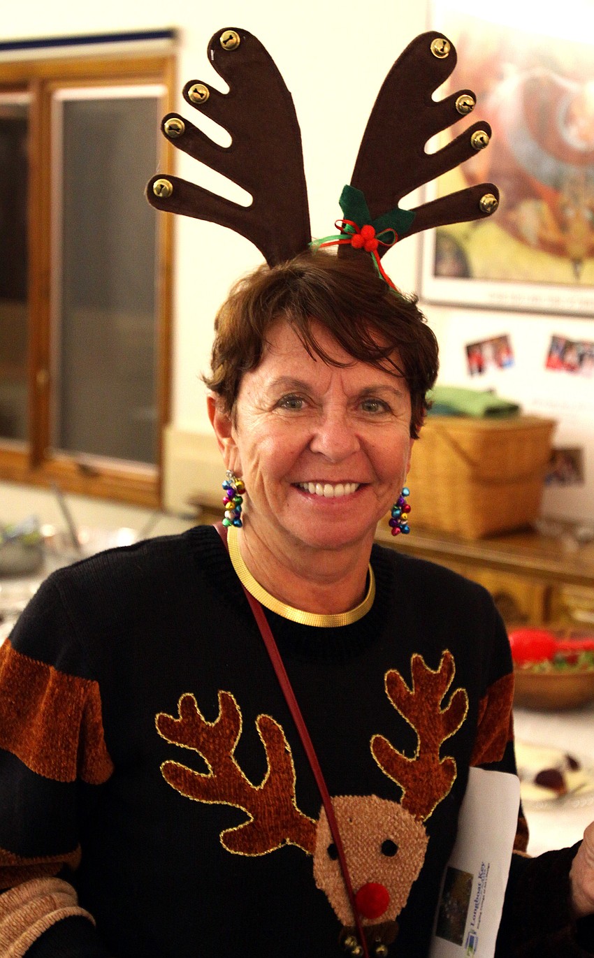 Carol Peschel got into the holiday spirit by wearing a reindeer sweater and antlers, Thursday, Dec. 8 at the Longboat Key Garden Clubâ€™s Candy Cane Lane at All Angels Church by the Sea.
